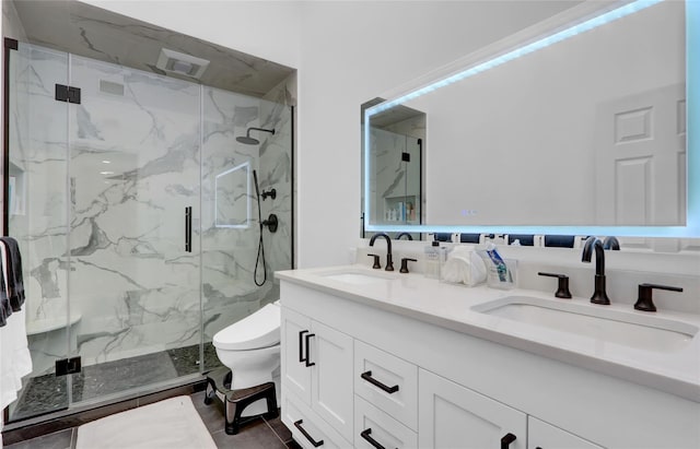 full bathroom featuring a marble finish shower, toilet, and double vanity