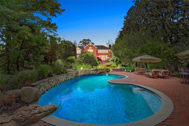 outdoor pool with a patio area