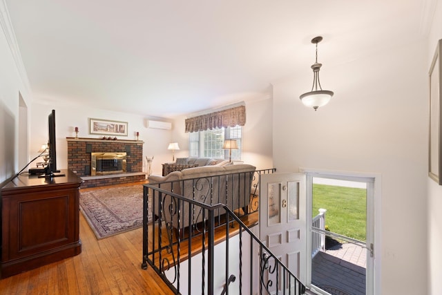 8 Anna D Ct, Hopewell Junction, NY 12533 - stairs featuring hardwood / wood-style floors, ornamental molding, an AC wall unit, and a brick fireplace