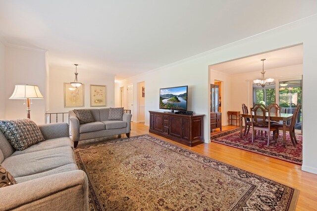 8 Anna D Ct, Hopewell Junction, NY 12533 - living room with light wood-style floors, a chandelier, and ornamental molding