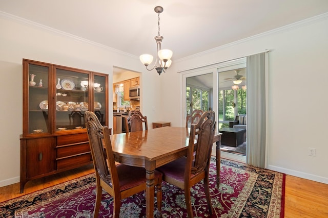 8 Anna D Ct, Hopewell Junction, NY 12533 - dining area featuring crown molding, light wood-style floors, a chandelier, and baseboards