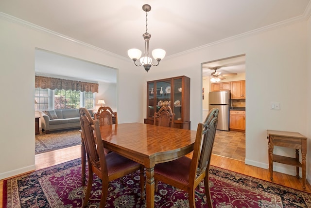 8 Anna D Ct, Hopewell Junction, NY 12533 - dining space with light wood-style floors, crown molding, a chandelier, baseboards, and a ceiling fan