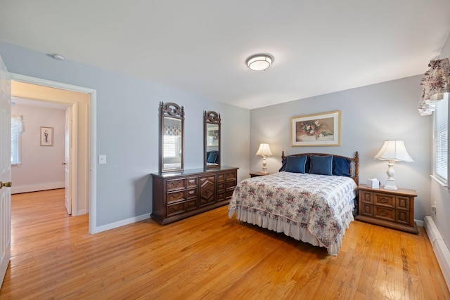 8 Anna D Ct, Hopewell Junction, NY 12533 - bedroom featuring a baseboard heating unit, light wood-style flooring, multiple windows, and baseboards