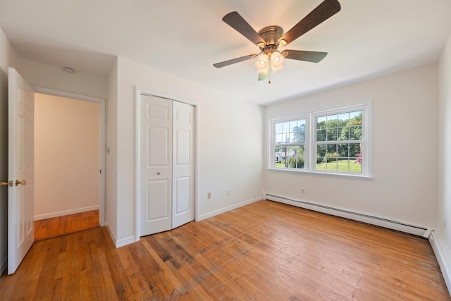 8 Anna D Ct, Hopewell Junction, NY 12533 - unfurnished bedroom featuring baseboard heating, wood-type flooring, a closet, ceiling fan, and baseboards