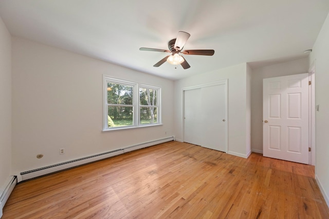 8 Anna D Ct, Hopewell Junction, NY 12533 - unfurnished bedroom with a baseboard radiator, light wood-style flooring, a closet, a ceiling fan, and baseboards
