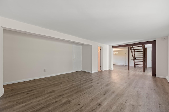 8 Anna D Ct, Hopewell Junction, NY 12533 - unfurnished living room with a chandelier, wood finished floors, baseboards, and stairs