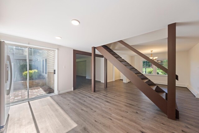 8 Anna D Ct, Hopewell Junction, NY 12533 - unfurnished living room with wood finished floors, a chandelier, stairs, baseboards, and recessed lighting