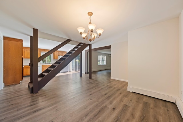 8 Anna D Ct, Hopewell Junction, NY 12533 - unfurnished dining area featuring a chandelier, light wood-style flooring, stairs, baseboards, and a baseboard heating unit