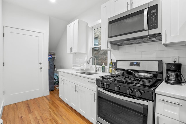 41AKA43 Sherwood Ave, Yonkers, NY 10704 - kitchen featuring appliances with stainless steel finishes, a sink, backsplash, light countertops, and white cabinets