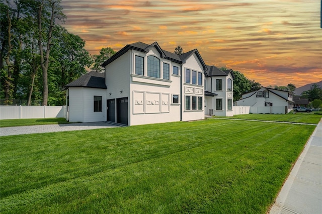 1259 Waterview Dr, Rockville Centre, NY 11570 - view of front of home featuring a garage, a patio area, driveway, and stucco siding