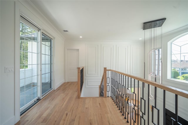 1259 Waterview Dr, Rockville Centre, NY 11570 - corridor featuring an upstairs landing, light wood finished floors, plenty of natural light, ornamental molding, and baseboards