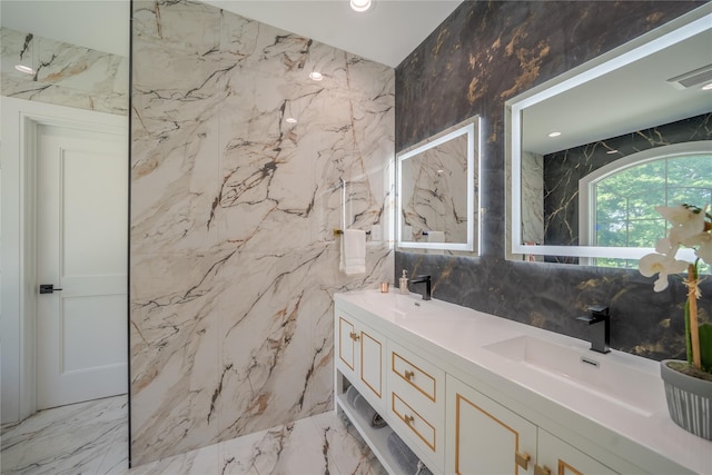1259 Waterview Dr, Rockville Centre, NY 11570 - bathroom with stone wall, marble tiled flooring, tile walls, and double vanity