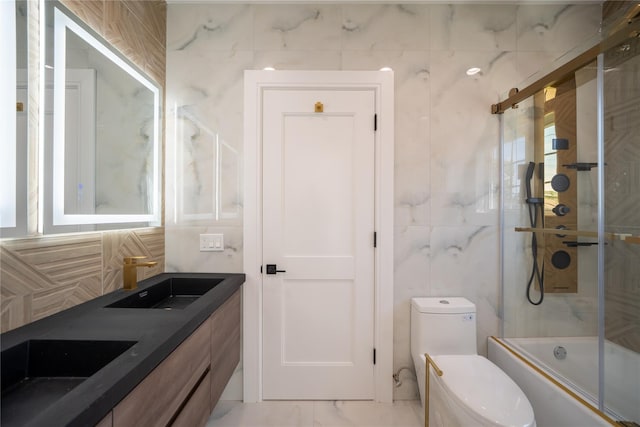 1259 Waterview Dr, Rockville Centre, NY 11570 - bathroom featuring toilet, shower / bath combination with glass door, marble look tile flooring, tile walls, and double vanity