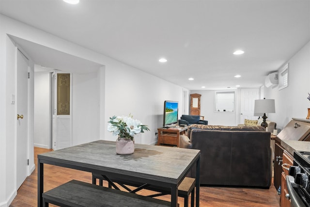 dining space with recessed lighting, dark wood-type flooring, and a wall mounted air conditioner