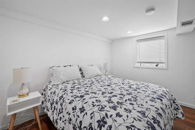 bedroom featuring wood finished floors, recessed lighting, and baseboards