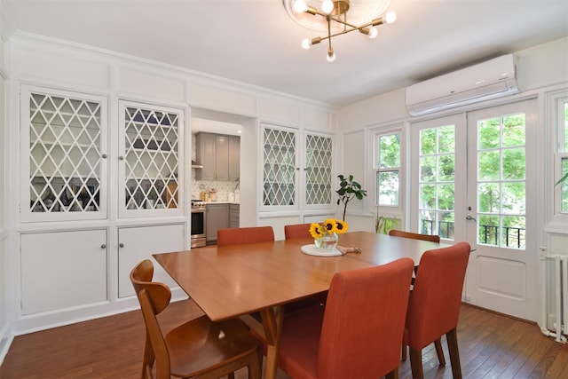 dining room featuring a wall unit AC, dark wood-style floors, and a chandelier