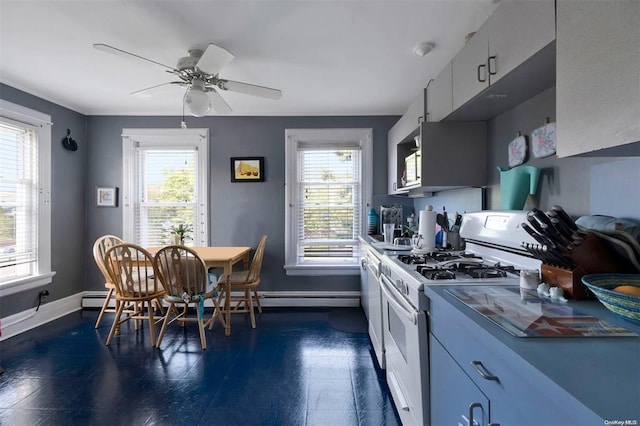 80 Monell Ave, Islip, NY 11751 - kitchen with white gas stove, baseboards, and a ceiling fan