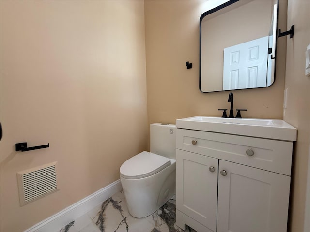 half bathroom with marble finish floors, baseboards, vanity, and toilet