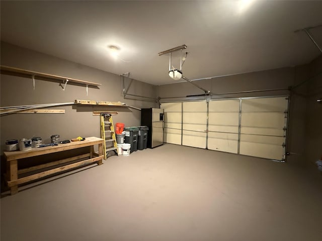garage with a garage door opener and freestanding refrigerator