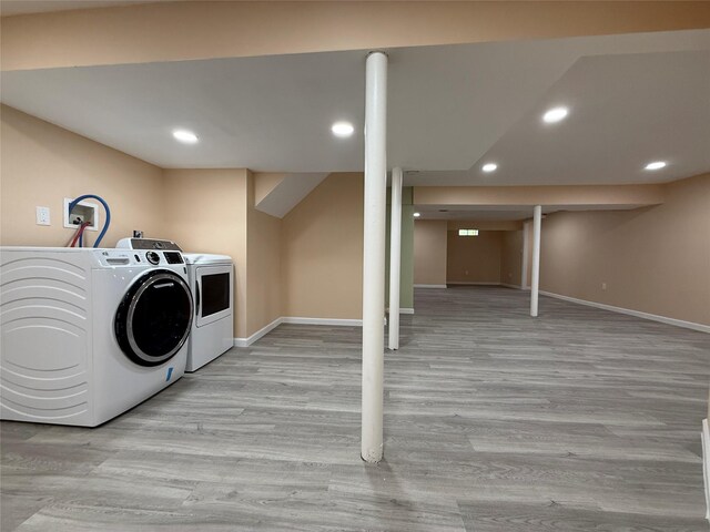 laundry area with baseboards, wood finished floors, recessed lighting, and separate washer and dryer