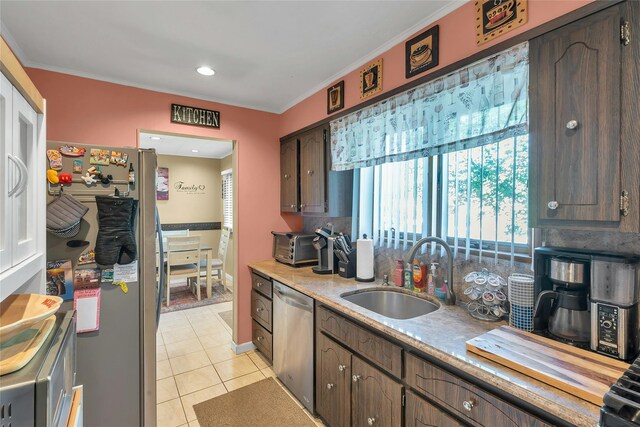 17 Gerhard Rd, Plainview, NY 11803 - kitchen with appliances with stainless steel finishes, a sink, light tile patterned floors, ornamental molding, and light countertops