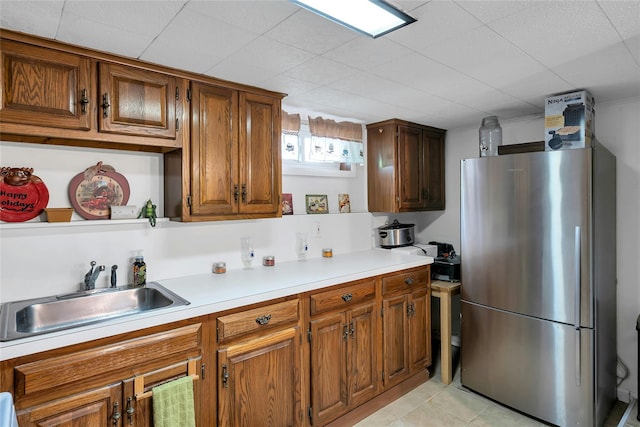 17 Gerhard Rd, Plainview, NY 11803 - kitchen featuring freestanding refrigerator, a sink, brown cabinets, light countertops, and open shelves