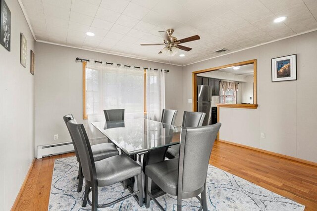 1544 Baldwin Blvd, Bay Shore, NY 11706 - dining space featuring a baseboard radiator, wood finished floors, a ceiling fan, baseboards, and recessed lighting