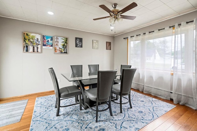 1544 Baldwin Blvd, Bay Shore, NY 11706 - dining room featuring a ceiling fan, wood finished floors, recessed lighting, ornamental molding, and baseboards