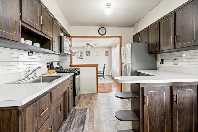1544 Baldwin Blvd, Bay Shore, NY 11706 - kitchen with stainless steel appliances, a sink, open shelves, and dark brown cabinets