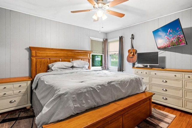 1544 Baldwin Blvd, Bay Shore, NY 11706 - bedroom featuring light wood-style floors, ceiling fan, and wooden walls