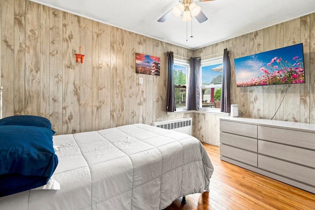 1544 Baldwin Blvd, Bay Shore, NY 11706 - bedroom with radiator heating unit, wood walls, wood-type flooring, and ceiling fan