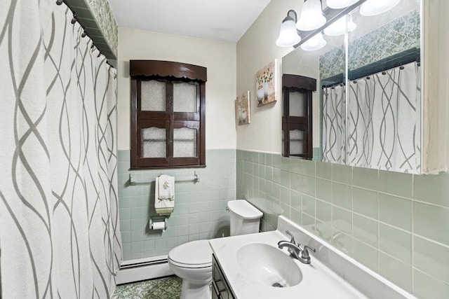 1544 Baldwin Blvd, Bay Shore, NY 11706 - full bathroom with a baseboard heating unit, toilet, vanity, tile walls, and a wainscoted wall