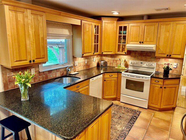 2 W Rd, East Setauket, NY 11733 - kitchen with white appliances, a sink, under cabinet range hood, a peninsula, and glass insert cabinets