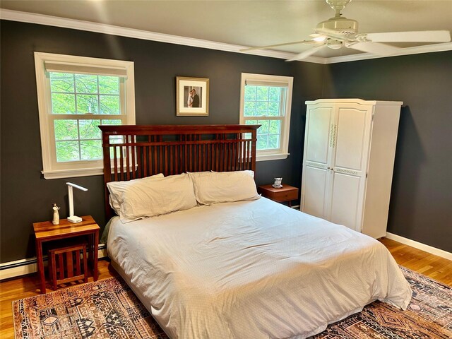 2 W Rd, East Setauket, NY 11733 - bedroom featuring ornamental molding, wood finished floors, baseboards, and ceiling fan