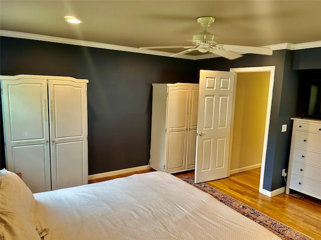 2 W Rd, East Setauket, NY 11733 - bedroom with wood finished floors, ornamental molding, baseboards, a ceiling fan, and a closet