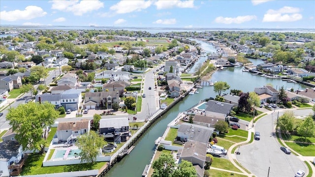 aerial view of property's location featuring nearby suburban area and a large body of water