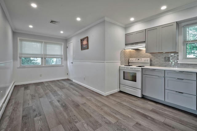 93 Broadway, Massapequa Park, NY 11762 - kitchen with white electric range oven, gray cabinets, a baseboard heating unit, crown molding, and under cabinet range hood