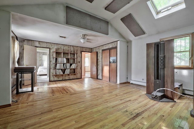 93 Broadway, Massapequa Park, NY 11762 - unfurnished room featuring lofted ceiling, plenty of natural light, hardwood / wood-style flooring, a skylight, and wood walls
