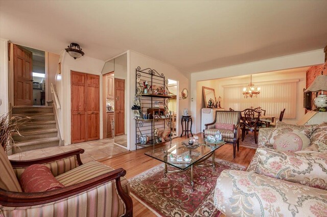 3176 Benjamin Rd, Oceanside, NY 11572 - living area with a chandelier, light wood-style flooring, and stairs