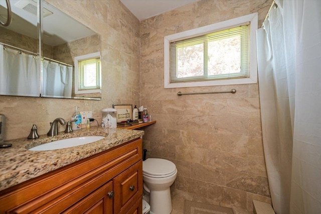 3176 Benjamin Rd, Oceanside, NY 11572 - full bath featuring vanity, toilet, tile walls, and curtained shower