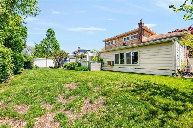 3176 Benjamin Rd, Oceanside, NY 11572 - back of property featuring central AC unit and a chimney