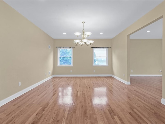 12 Pleasant Ave, Port Washington, NY 11050 - empty room with a chandelier, light wood-style floors, baseboards, and recessed lighting