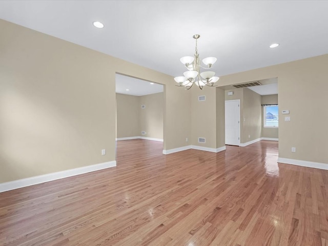 12 Pleasant Ave, Port Washington, NY 11050 - spare room featuring a chandelier, light wood-style flooring, recessed lighting, and baseboards