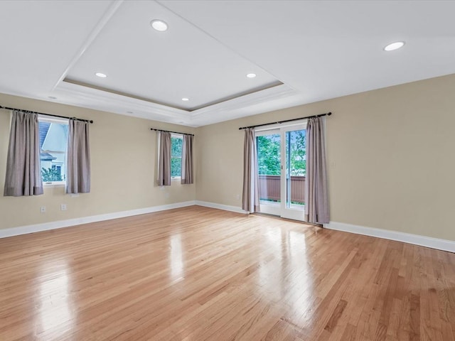 12 Pleasant Ave, Port Washington, NY 11050 - empty room featuring plenty of natural light, a raised ceiling, light wood-style flooring, baseboards, and recessed lighting