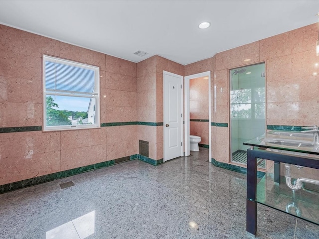 12 Pleasant Ave, Port Washington, NY 11050 - unfurnished room with a sink and tile walls