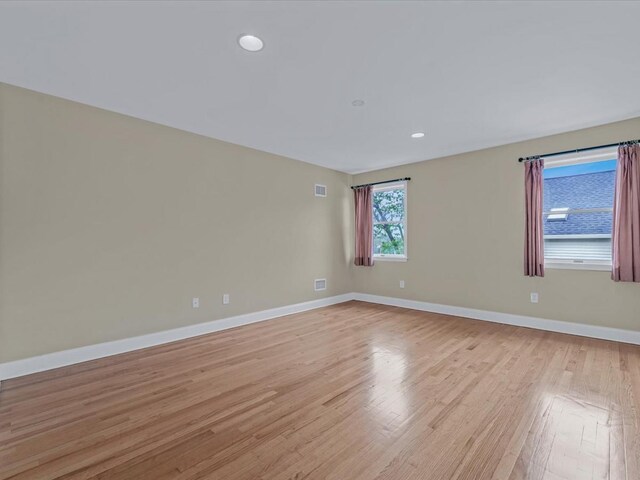 12 Pleasant Ave, Port Washington, NY 11050 - spare room featuring light wood finished floors, baseboards, and recessed lighting