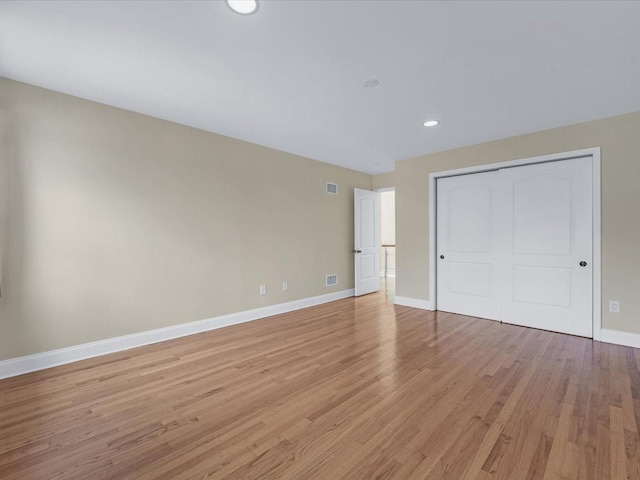 12 Pleasant Ave, Port Washington, NY 11050 - unfurnished bedroom with light wood-style flooring, baseboards, a closet, and recessed lighting
