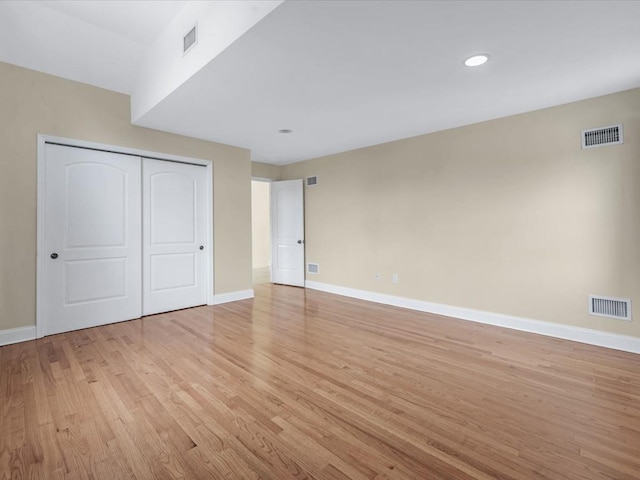 12 Pleasant Ave, Port Washington, NY 11050 - unfurnished bedroom with baseboards, light wood-style floors, a closet, and recessed lighting