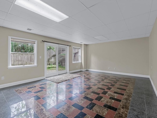 12 Pleasant Ave, Port Washington, NY 11050 - spare room featuring healthy amount of natural light, baseboards, and a drop ceiling