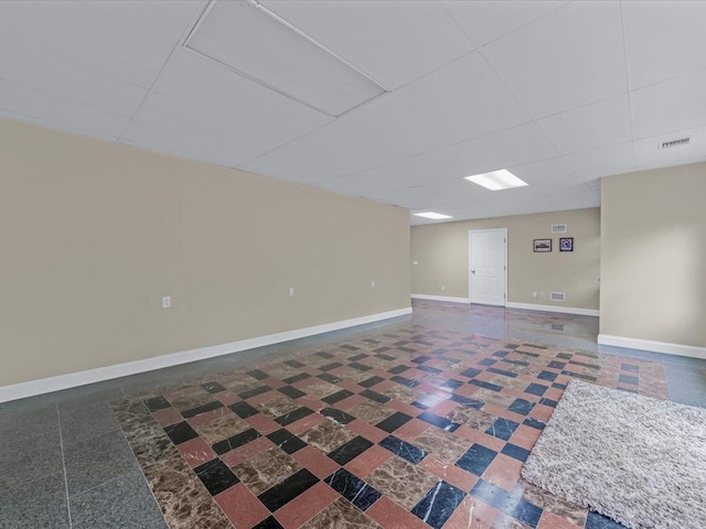 12 Pleasant Ave, Port Washington, NY 11050 - below grade area featuring a drop ceiling and baseboards